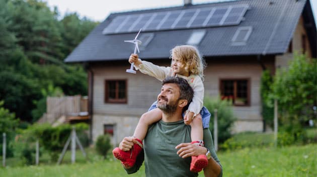 Father and child playing in front of home