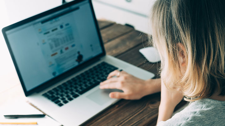 Woman attempting to adjust to the screensize on her laptop