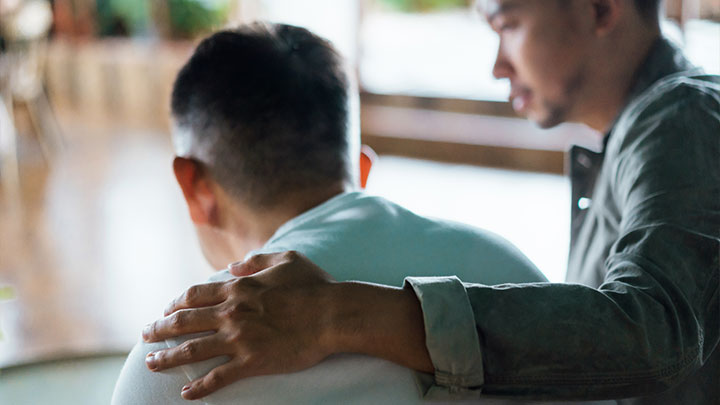 Man helping another man