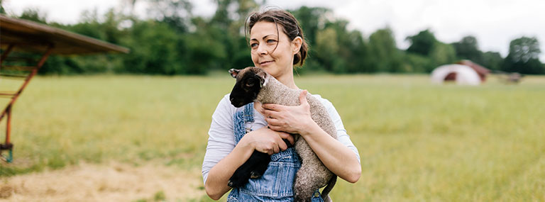 Woman holding a lamb